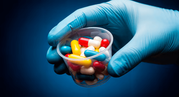 hand-holding-cup-pills-23-2152008057